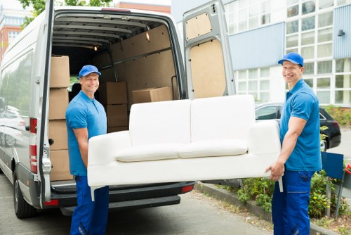 Professional house removalists loading moving boxes in Watford