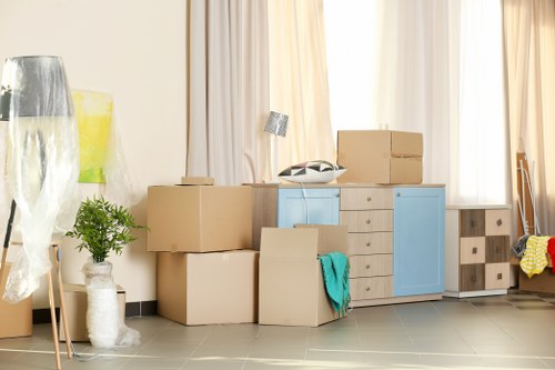 Man and van pricing discussion with boxes and moving van in Watford