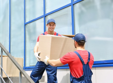 Removals crew loading items into a van in Watford