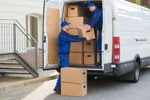 Safe loading practices beside a van during a move