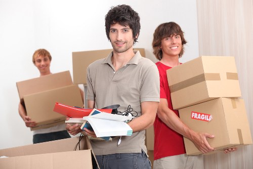 Same day removal team transporting boxes through Watford