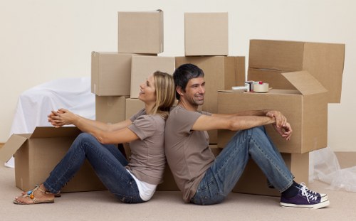Professional movers carrying furniture in Watford