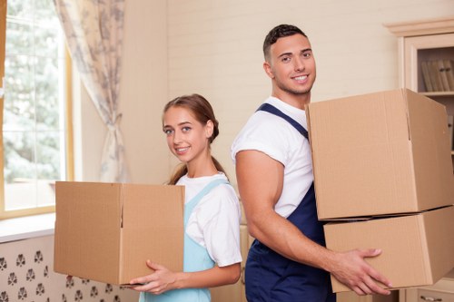 House movers carefully carrying furniture during a Watford relocation