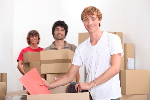 Packed office equipment and furniture prepared for transport in Watford